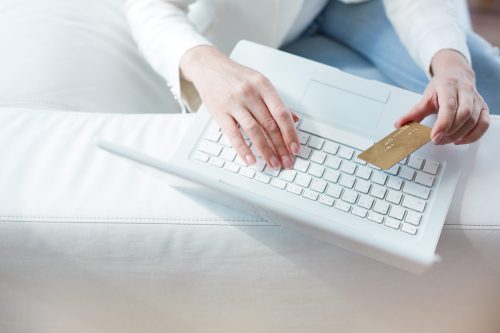 Hands Of Female Sitting At The Laptop With A Credit Card